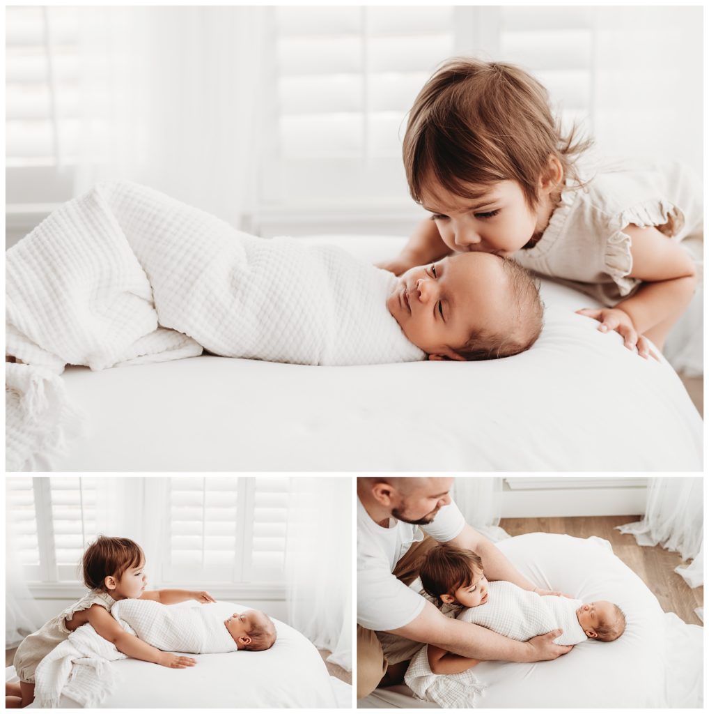 big sister kissing baby brother on beanbag in castle rock newborn photo studio