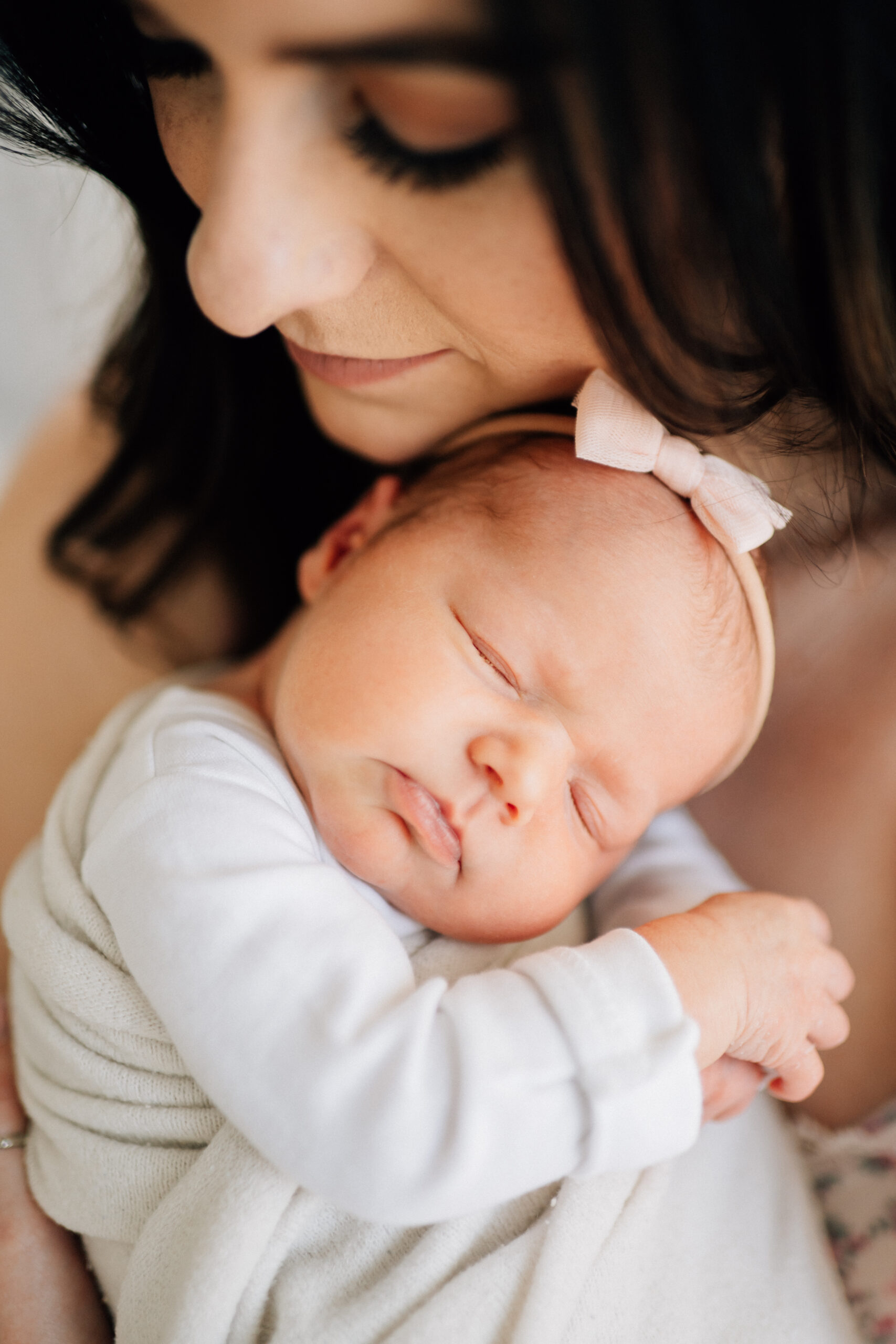 denver newborn session curled upon mom's shoulder