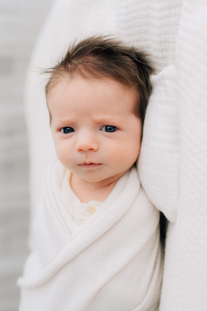 swaddled newborn lying safely on blankets